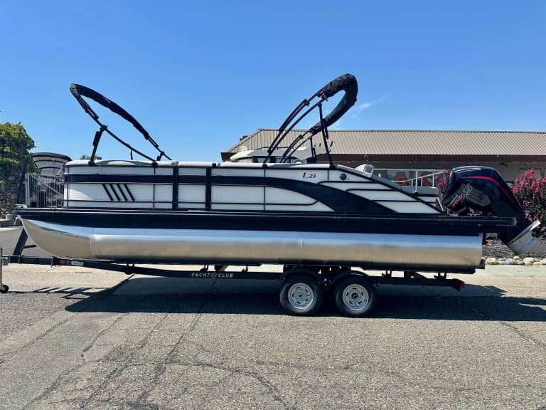Bennington L 23FT pontoon boat with Mercury 200HP Pro XS engine on trailer.