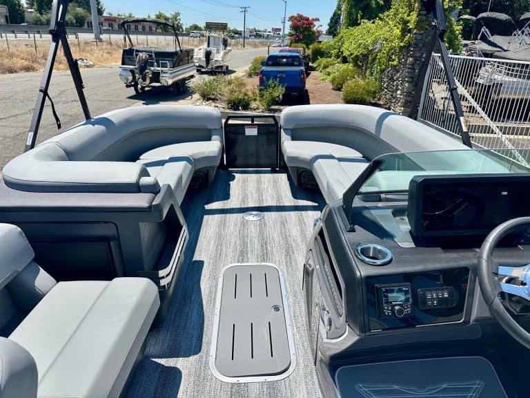 Boat interior with spacious lounge seating and modern dashboard for optimal boating experience.