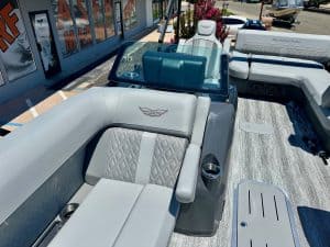 Boat interior with modern seating and dashboard at a dealership.