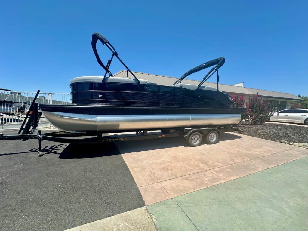Modern luxury pontoon boat on trailer, ideal for leisure and water adventures.