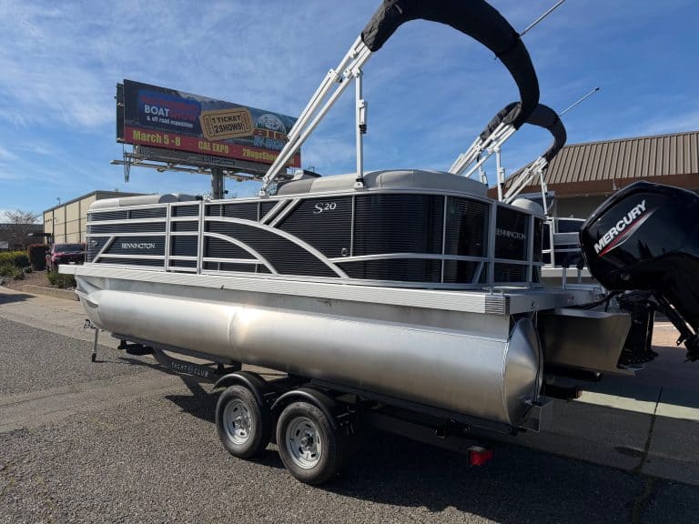 Bennington 20SSR pontoon boat with Mercury outboard motor on trailer.