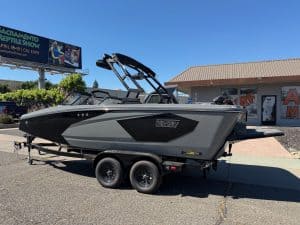 Surf boat on trailer at dealership.