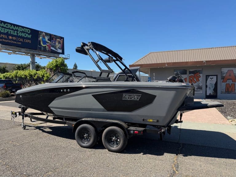 Surf boat on trailer at dealership.