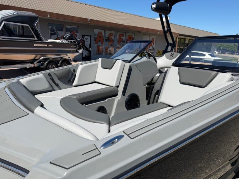 Luxury surf boat with modern seating and design for water sports.