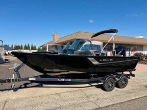 Black Lowe FM 1875 fishing boat on trailer with 150HP engine.
