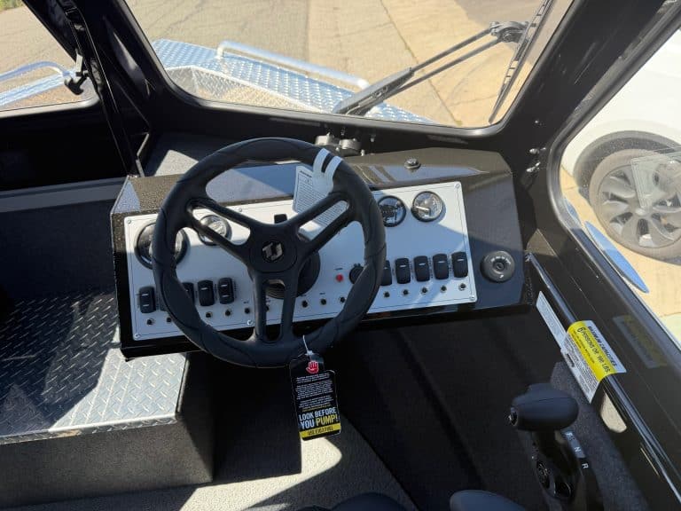 Close-up of Thunder Jet boat control panel with steering wheel and gauges.