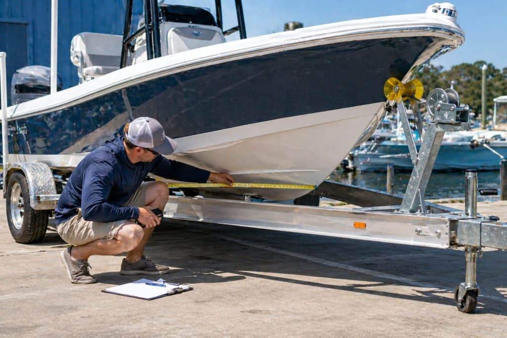 Boat trailer being inspected for safety and proper alignment before launching a boat.
