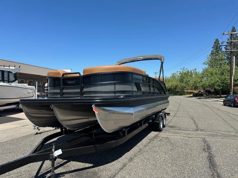 Bennington M 24 boat with Mercury 200HP outboard motor on trailer.