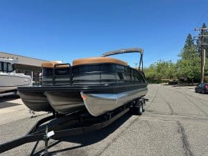 Bennington M 24 boat with Mercury 200HP outboard engine on trailer.