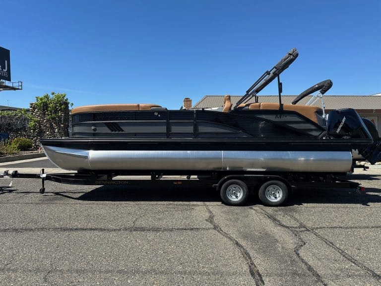 Bennington M 24 pontoon boat with Mercury 200HP outboard motor on trailer.