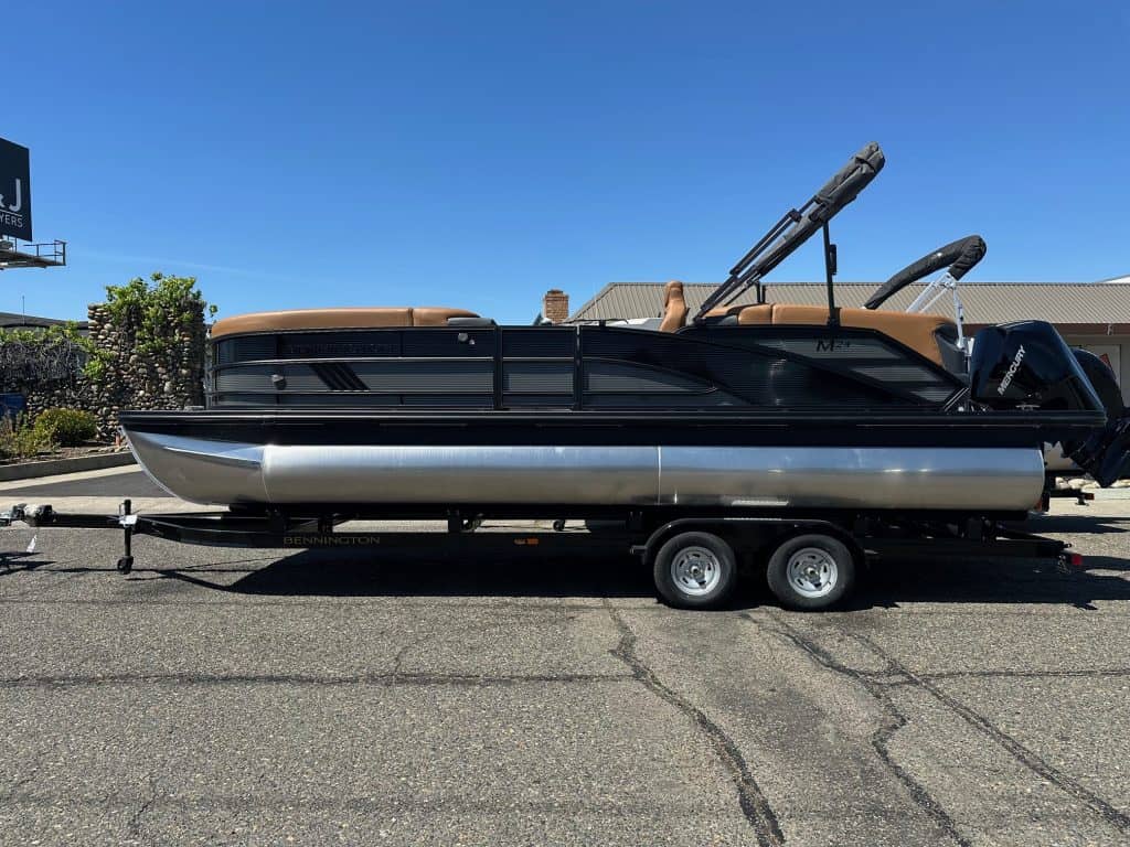Bennington M 24 pontoon boat with Mercury 200HP outboard motor on trailer.