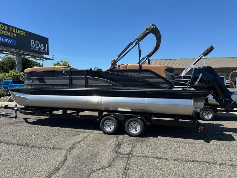 Bennington M 24 pontoon boat with Mercury 200HP outboard motor on trailer.