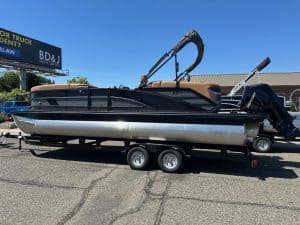 Bennington M 24 pontoon boat with Mercury 200HP outboard motor on trailer.