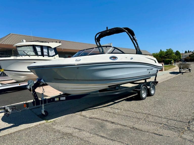 Bayliner VR6 boat on trailer at marina.
