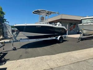 Robalo R180 boat on trailer at dealership lot.