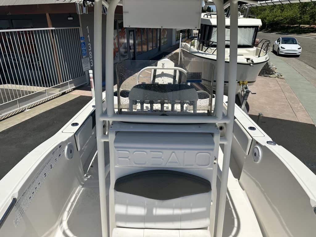 Close-up of a white boat with a steering console at ASFB Marine.