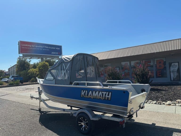 Klamath 19 GTX boat parked on trailer outside dealership.