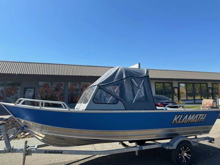 Klamath 19 GTX boat on trailer with canopy, outdoor display.