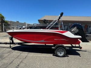 Red and white Bayliner M17 boat with Mercury 90HP engine on trailer.
