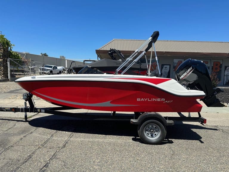 Red and white Bayliner M17 boat with Mercury 90HP engine on trailer.