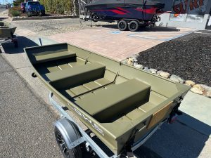 Aluminum fishing boat with spacious interior and durable construction.