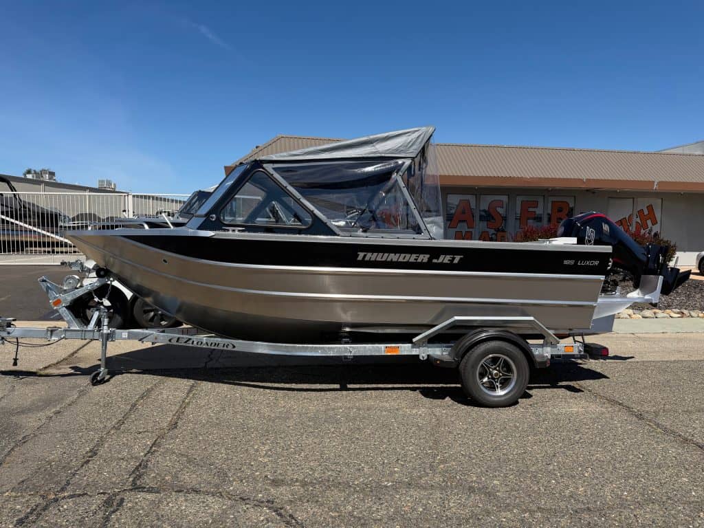Boat with Mercury 150HP engine on trailer, ideal for water sports and fishing.