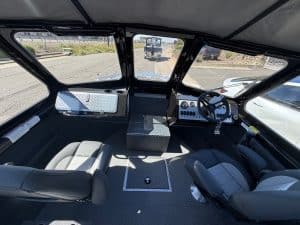 High-quality boat cockpit with steering wheel and control panel.