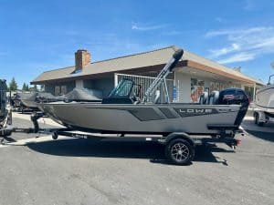 Boat with outboard motor on trailer, ready for water, at ASFB Marine dealership.