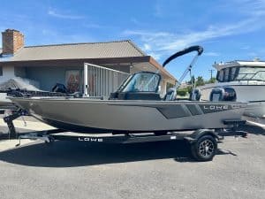 Lowe boat displayed on a trailer outside a marine dealership.