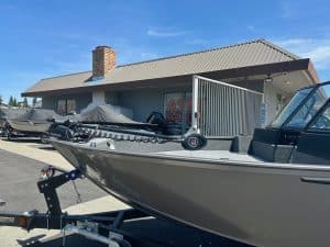 Boat and marine equipment at ASFB Marine dealership in front of a building.