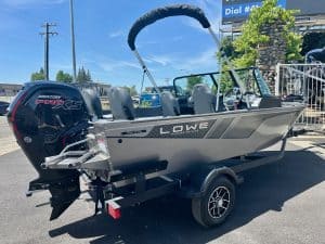 Modern Lowe aluminum fishing boat with Mercury outboard motor on trailer.