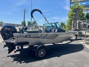 Boat with Lowe branding on trailer for sale at dealership.