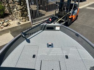 Boat deck with trolling motor and safety rails for fishing and boating activities.