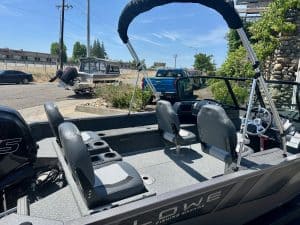 Boat interior with seating and steering console for fishing and leisure activities.