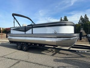 Modern Lowe pontoon boat on trailer, ideal for leisure and water activities.
