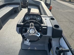 Opti boat dashboard with steering wheel and instrument gauges.