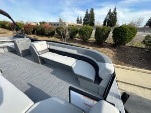 Pontoon boat with plush, spacious seating for relaxing on the water. Perfect for leisure, fishing, a.