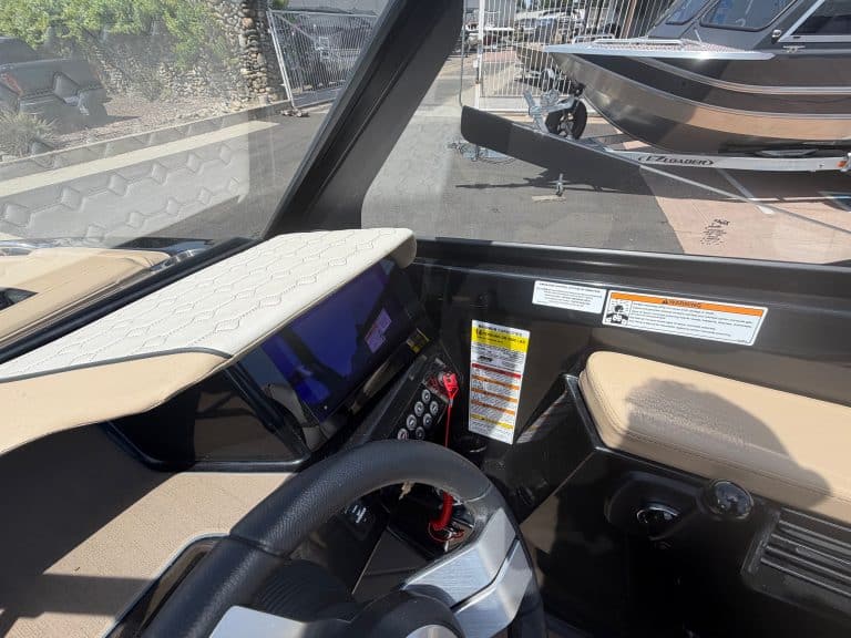 Modern boat dashboard with digital controls and navigation system.