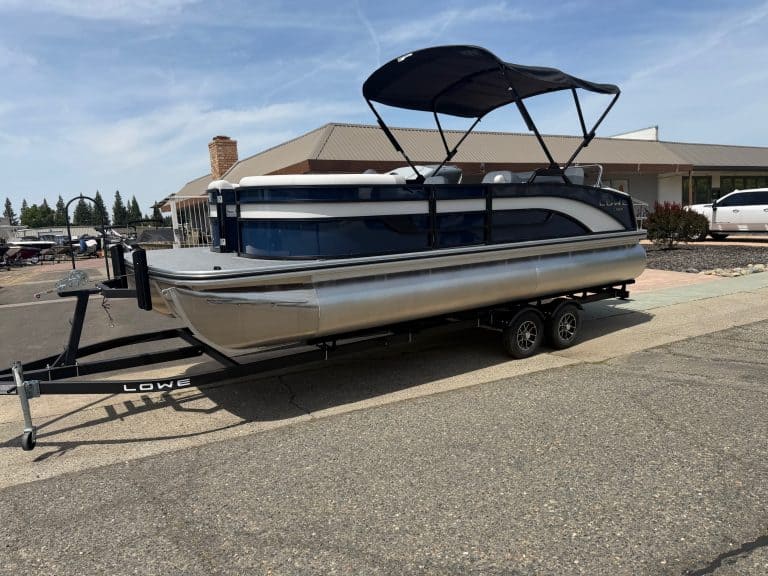 Pontoon boat on trailer with canopy, ideal for boating and outdoor recreation.