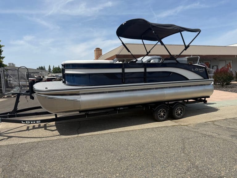 Modern pontoon boat with canopy on trailer, ideal for leisure and fishing.