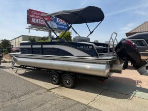 Pontoon boat with outboard motor, ideal for leisure and fishing adventures. Perfect for water recrea.