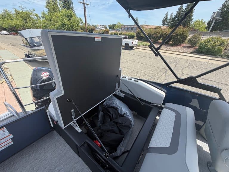 Boat storage compartment with cover open for easy access and maintenance.