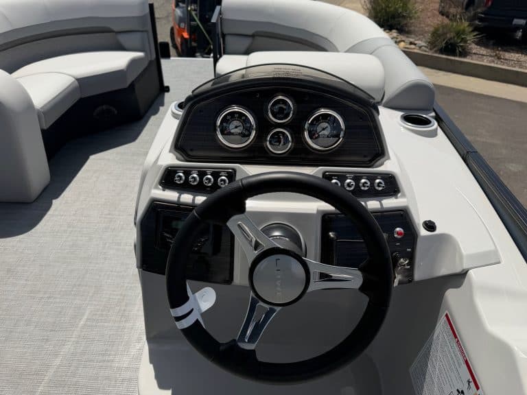 Marine boat dashboard with steering wheel and instrument gauges for optimal navigation.