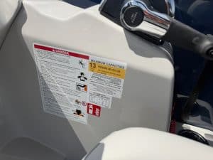 Marine vessel safety capacity label with weight and person limits.