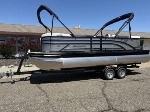 Pontoon boat with Bimini top and trailer for easy transport.
