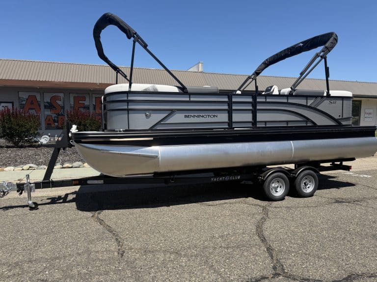 Pontoon boat with Bimini top and trailer for easy transport.