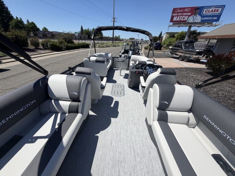 Luxury pontoon boat interior with comfortable seating and modern controls for boating adventures.