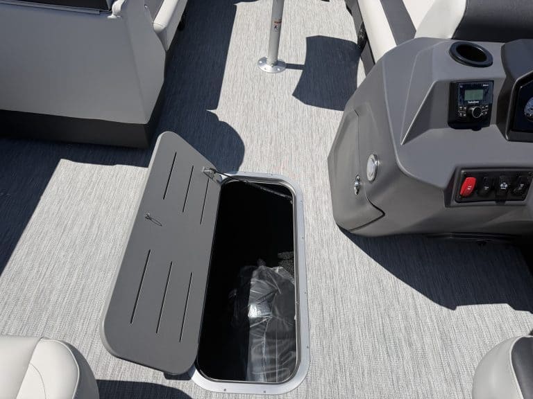 Boat deck storage compartment with open lid, part of a modern marine vessel.