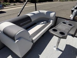 Bennington pontoon boat with comfortable seating and built-in table for outdoor relaxation.