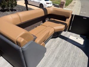 Luxury boat seating with tan and black upholstery on a Bennington M 23 model.